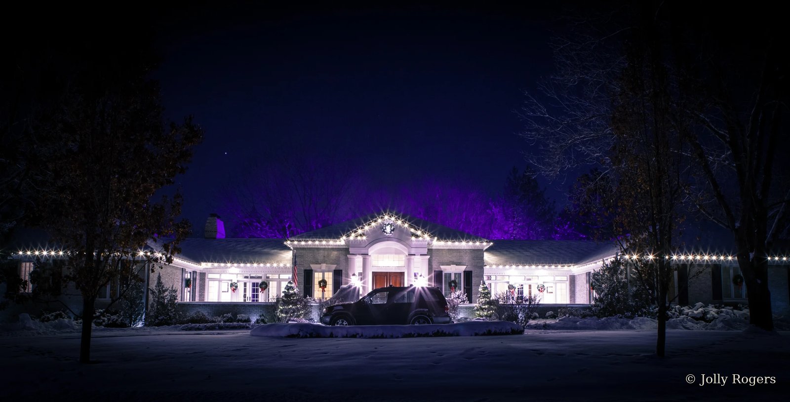 Estate roofline lighting with purple uplighting accent