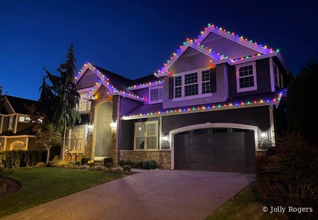 Multicolor roofline Christmas lights on two story home